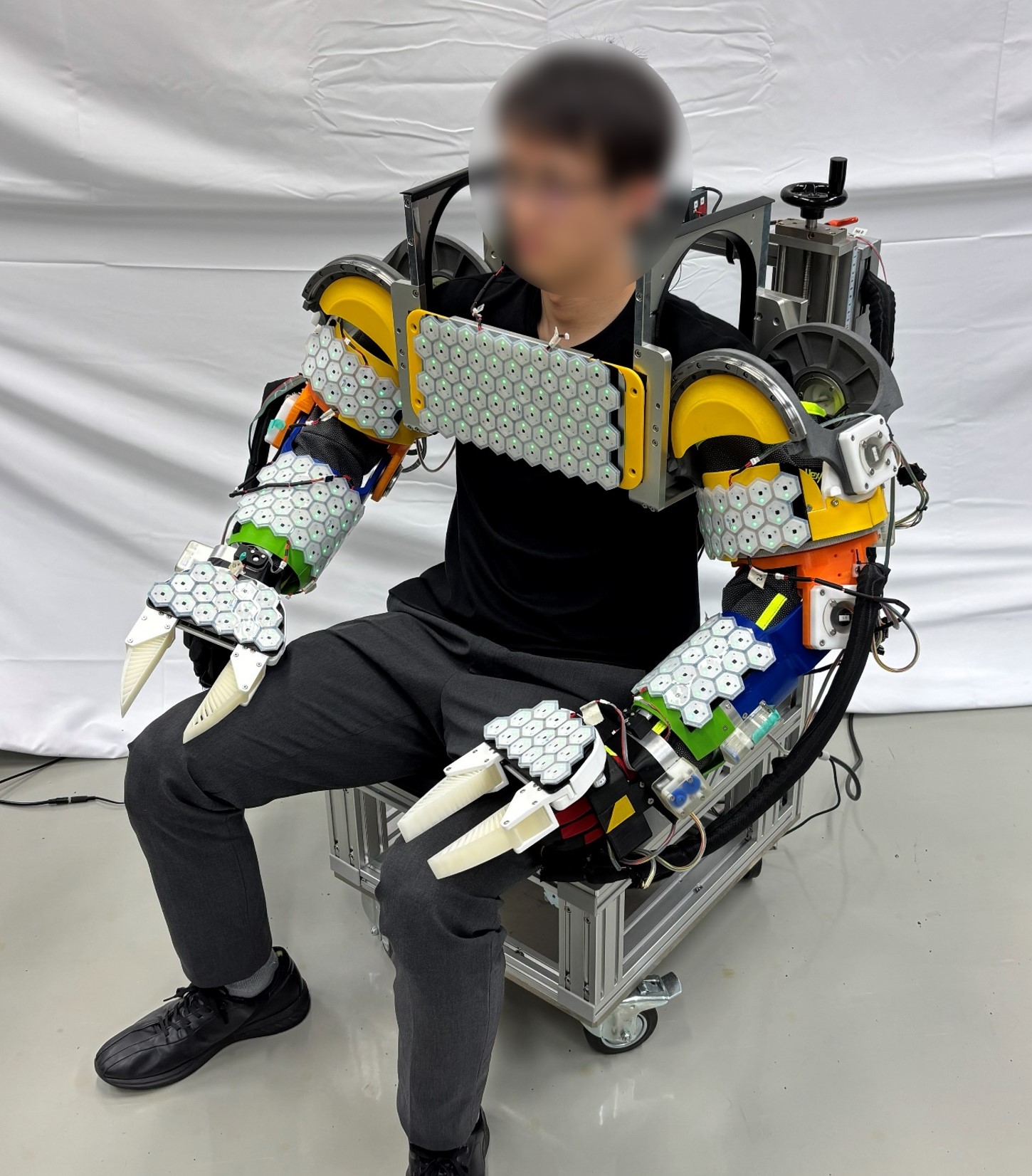 Operator wearing the TWINS Wearable Dual-Arm Device
